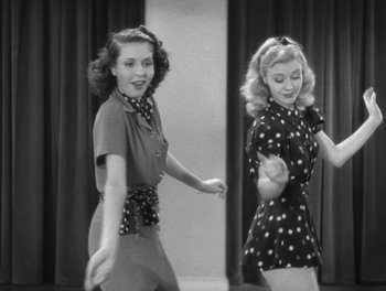 Movie still from “Stage Door” (1937), directed by Gregory La Cava – Two young women in polka dot outfits are dancing together; Medium shot, Low angle