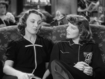 Movie still from “Stage Door” (1937), directed by Gregory La Cava – A couple of women sitting next to each other on top of a couch; Medium shot, Over the shoulder angle