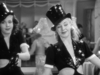 Movie still from “Stage Door” (1937), directed by Gregory La Cava – A woman wearing a top hat in a black dress; Medium shot, Low angle