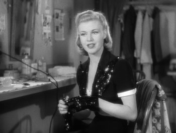Movie still from “Stage Door” (1937), directed by Gregory La Cava – A black and white photo of a woman in a dressing room; Medium shot, Over the shoulder angle