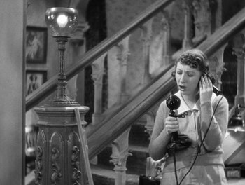Movie still from “Stage Door” (1937), directed by Gregory La Cava – An old photo of a woman using a hair dryer; Medium shot, High angle