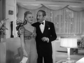 Movie still from “Stage Door” (1937), directed by Gregory La Cava – A man and a woman standing next to each other in a room; Medium shot, Low angle