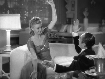 Movie still from “Stage Door” (1937), directed by Gregory La Cava – A man and a woman high - fiving each other; Medium shot, High angle