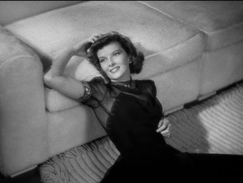 Movie still from “Stage Door” (1937), directed by Gregory La Cava – An old black and white photo of a woman laying on a couch; Medium shot, High angle