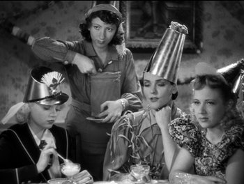 Movie still from “Stage Door” (1937), directed by Gregory La Cava – A group of people sitting at a table wearing party hats; Medium shot, High angle