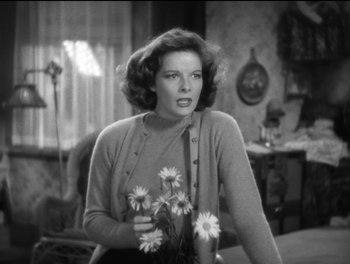 Movie still from “Stage Door” (1937), directed by Gregory La Cava – A black and white photo of a woman holding flowers; Close Up shot, Low angle