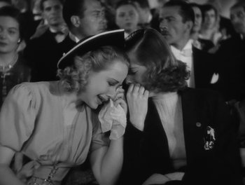 Movie still from “Stage Door” (1937), directed by Gregory La Cava – A woman crying in front of another woman in front of a crowd; Close Up shot, High angle