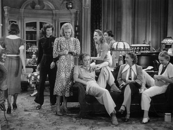 Movie still from “Stage Door” (1937), directed by Gregory La Cava – A black and white photo of a group of people sitting on a couch; Wide shot, High angle