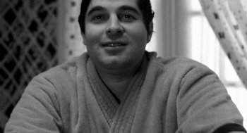 Movie still from “Stardust Memories” (1980), directed by Woody Allen – A black and white photo of a man in a robe; Close Up shot, High angle