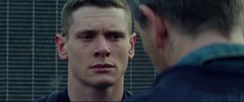 Movie still from “Starred Up” (2013), directed by David Mackenzie – A person looking at a person; Close Up shot, Over the shoulder angle