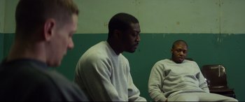 Movie still from “Starred Up” (2013), directed by David Mackenzie – A group of people sitting in a room; Medium shot, Over the shoulder angle