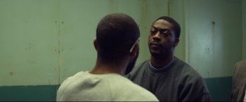Movie still from “Starred Up” (2013), directed by David Mackenzie – A man looking at himself in the mirror; Close Up shot, Over the shoulder angle