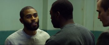 Movie still from “Starred Up” (2013), directed by David Mackenzie – Two men are talking in a room; Medium shot, Over the shoulder angle