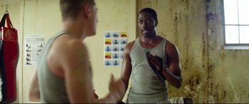 Movie still from “Starred Up” (2013), directed by David Mackenzie – A man talking to another man in front of a bathroom mirror; Medium shot, Over the shoulder angle