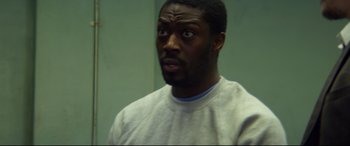 Movie still from “Starred Up” (2013), directed by David Mackenzie – A man with a surprised look on his face; Close Up shot, High angle