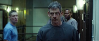 Movie still from “Starred Up” (2013), directed by David Mackenzie – A person with blood on his face; Close Up shot, Over the shoulder angle