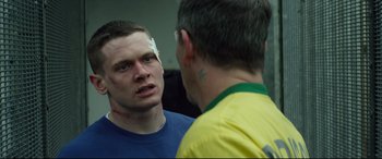 Movie still from “Starred Up” (2013), directed by David Mackenzie – A man with bandages on his head and a man with a bandage on his face; Close Up shot, Over the shoulder angle