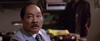 Movie still from “Starsky & Hutch” (2004), directed by Todd Phillips – An older man wearing a suit and a tie; Close Up shot, High angle