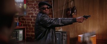 Movie still from “Starsky & Hutch” (2004), directed by Todd Phillips – A man in a black leather jacket and a black hat; Medium shot, Low angle