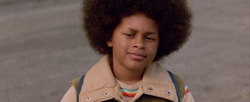 Movie still from “Starsky & Hutch” (2004), directed by Todd Phillips – A young boy with an afro is smiling for the camera; Close Up shot, Low angle