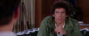 Movie still from “Starsky & Hutch” (2004), directed by Todd Phillips – A man sitting on a couch looking at the camera; Close Up shot, Over the shoulder angle