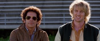 Movie still from “Starsky & Hutch” (2004), directed by Todd Phillips – Two people wearing sunglasses and one is wearing a brown jacket; Close Up shot, Low angle