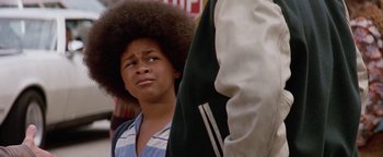 Movie still from “Starsky & Hutch” (2004), directed by Todd Phillips – A young man with a large afro looking up; Close Up shot, Low angle