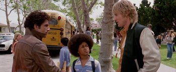 Movie still from “Starsky & Hutch” (2004), directed by Todd Phillips – A group of people standing next to each other near a bus; Medium shot, Over the shoulder angle