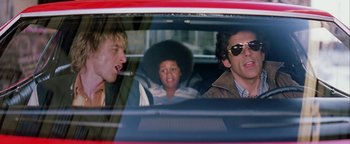 Movie still from “Starsky & Hutch” (2004), directed by Todd Phillips – A group of people sitting in the back seat of a car; Medium shot, Low angle