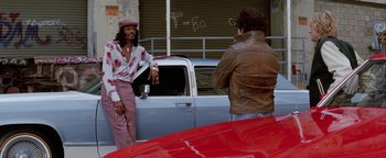 Movie still from “Starsky & Hutch” (2004), directed by Todd Phillips – Two men standing in front of a red car; Wide shot, Low angle