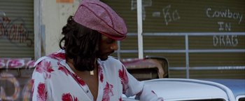 Movie still from “Starsky & Hutch” (2004), directed by Todd Phillips – A woman wearing a pink hat looking down at a table; Close Up shot, Low angle