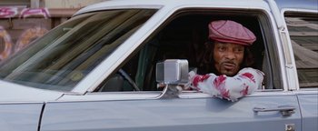 Movie still from “Starsky & Hutch” (2004), directed by Todd Phillips – A man sitting in the driver's seat of a car; Medium shot, Low angle