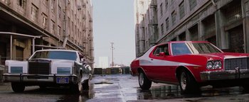 Movie still from “Starsky & Hutch” (2004), directed by Todd Phillips – A red and white car parked on the side of the street; Wide shot, High angle