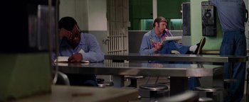 Movie still from “Starsky & Hutch” (2004), directed by Todd Phillips – Two men sitting at a table in front of each other; Medium shot, High angle