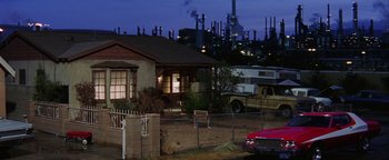 Movie still from “Starsky & Hutch” (2004), directed by Todd Phillips – An oil refinery in the distance behind a house; Extreme Wide shot, Low angle
