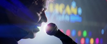 Movie still from “Starsky & Hutch” (2004), directed by Todd Phillips – A man is singing into a microphone; Extreme Close Up shot, Low angle