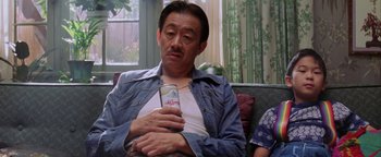 Movie still from “Starsky & Hutch” (2004), directed by Todd Phillips – An older man holding a cell phone in his hands; Medium shot, Low angle