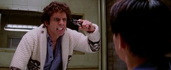 Movie still from “Starsky & Hutch” (2004), directed by Todd Phillips – A man holding a knife in front of a mirror; Close Up shot, Over the shoulder angle