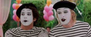Movie still from “Starsky & Hutch” (2004), directed by Todd Phillips – Two mimes are dressed up and posing for a picture; Close Up shot, Over the shoulder angle