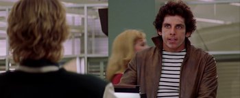 Movie still from “Starsky & Hutch” (2004), directed by Todd Phillips – A man in a brown leather jacket sitting next to a woman in a black and white striped shirt; Close Up shot, Over the shoulder angle