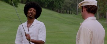 Movie still from “Starsky & Hutch” (2004), directed by Todd Phillips – A man in a white shirt is standing in a field; Close Up shot, Over the shoulder angle