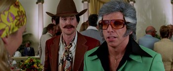 Movie still from “Starsky & Hutch” (2004), directed by Todd Phillips – A man in a cowboy hat standing next to another man in sunglasses; Close Up shot, Low angle
