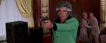 Movie still from “Starsky & Hutch” (2004), directed by Todd Phillips – A man in a green jacket is holding a gun; Close Up shot, Over the shoulder angle