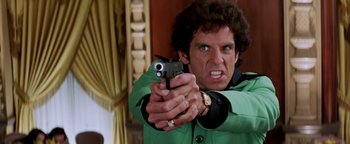 Movie still from “Starsky & Hutch” (2004), directed by Todd Phillips – A man in a green jacket is holding a gun; Close Up shot, Low angle