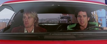 Movie still from “Starsky & Hutch” (2004), directed by Todd Phillips – Two people in the back seat of a red car; Medium shot, Over the shoulder angle