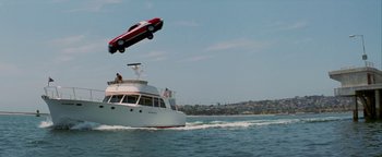 Movie still from “Starsky & Hutch” (2004), directed by Todd Phillips – A car is flying over a boat in the water; Extreme Wide shot, Low angle