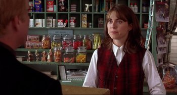 Movie still from “State and Main” (2000), directed by David Mamet – A woman standing in front of a counter in a store; Medium shot, Over the shoulder angle