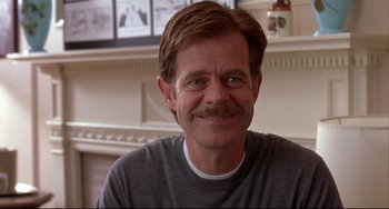 Movie still from “State and Main” (2000), directed by David Mamet – A person with a mustache; Close Up shot, Over the shoulder angle