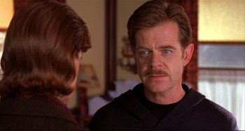 Movie still from “State and Main” (2000), directed by David Mamet – A person with a beard and a mustache; Close Up shot, Over the shoulder angle
