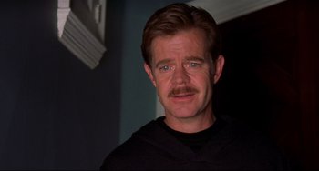 Movie still from “State and Main” (2000), directed by David Mamet – A person with a mustache; Close Up shot, Over the shoulder angle